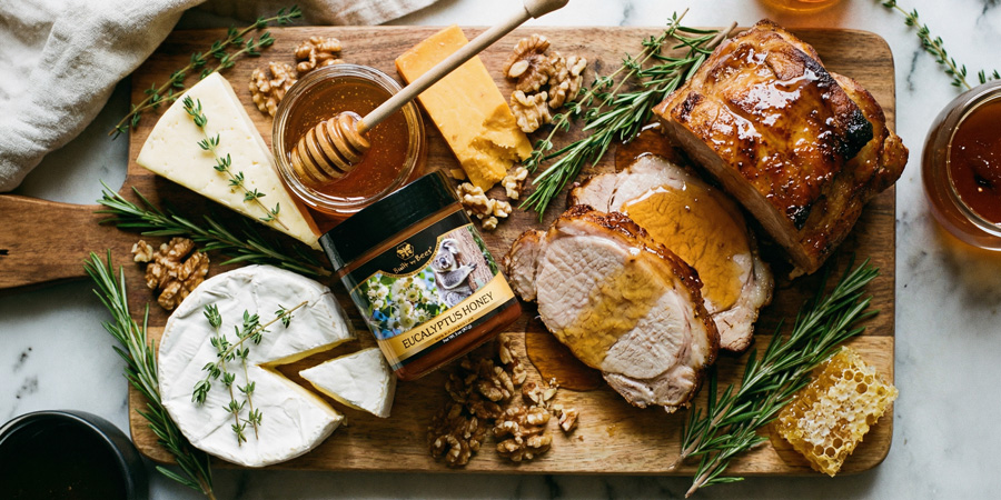 Charcuterie board with roasted pork, cheeses, walnuts, herbs and eucalyptus honey jar with 微电影啪啪
